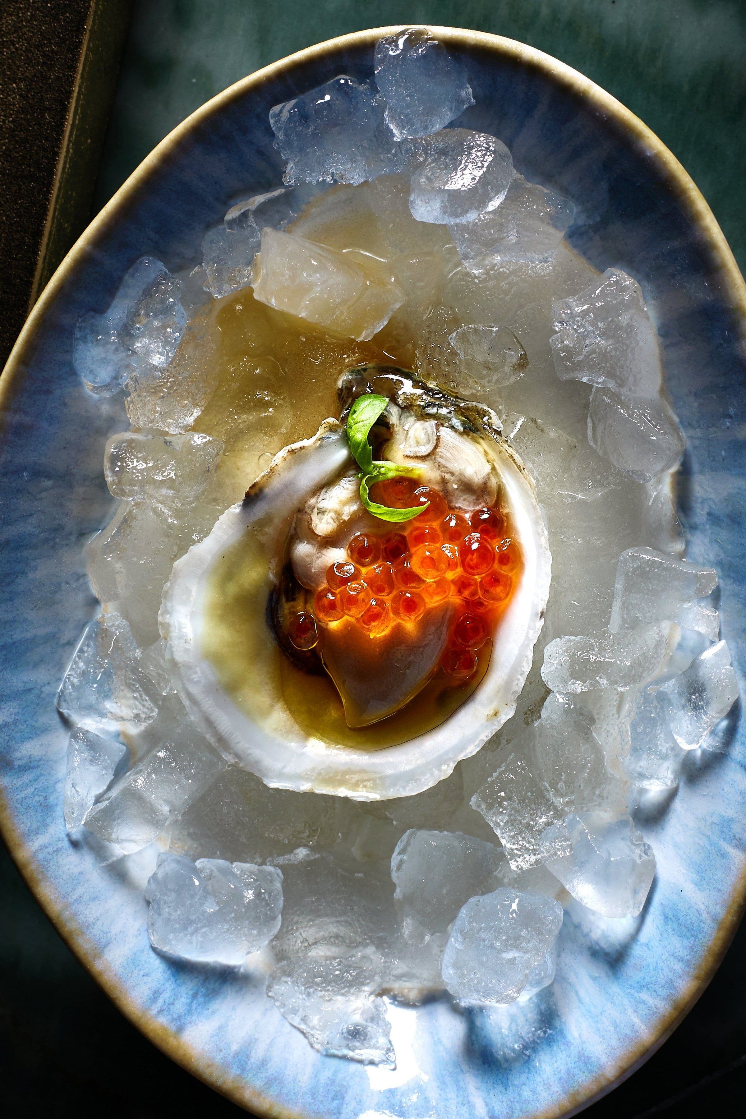 Gulf oyster with ikura on shaved ice